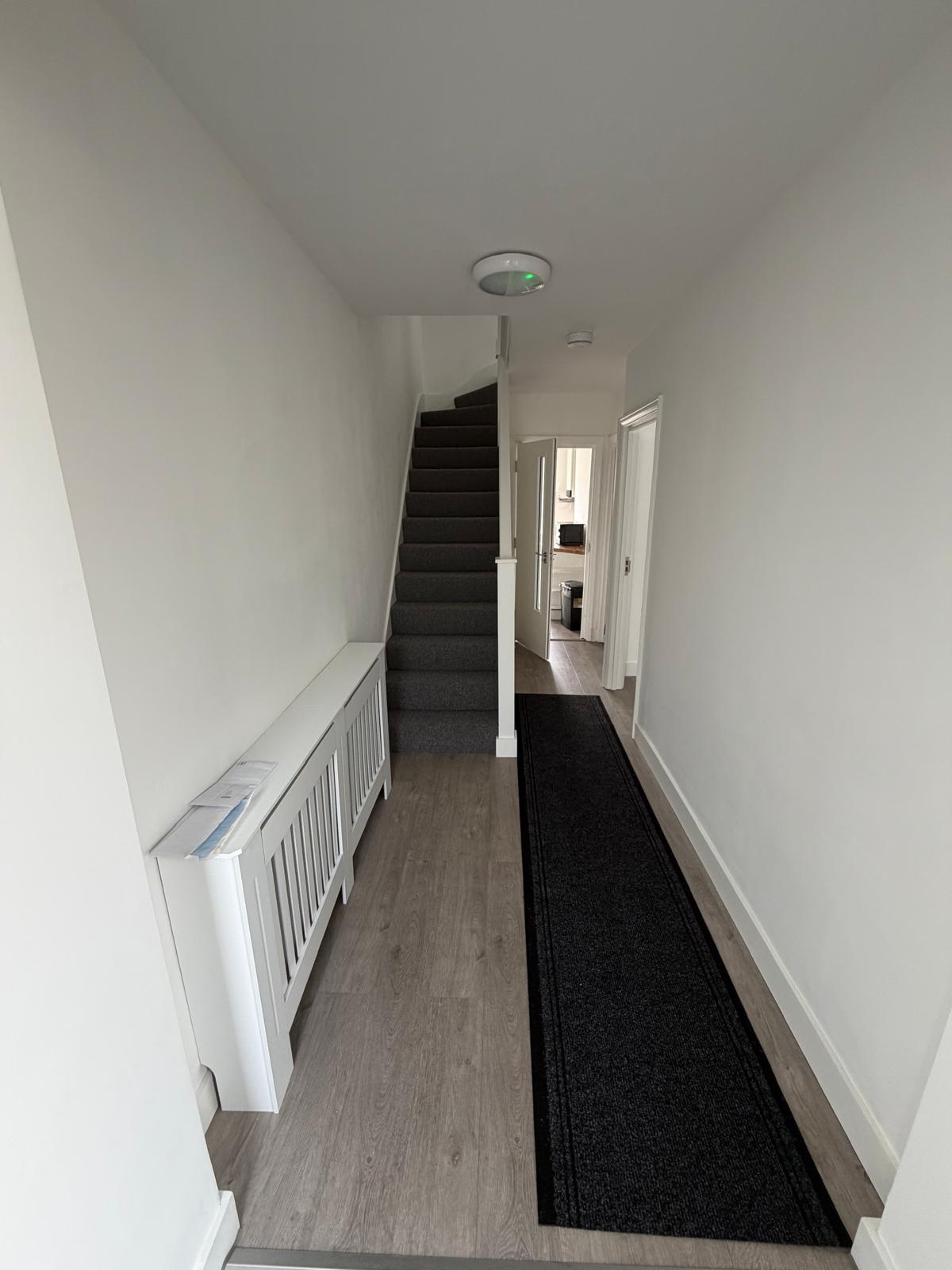 Clean and well-kept hallway and staircase at a Kope-Medics supported living home